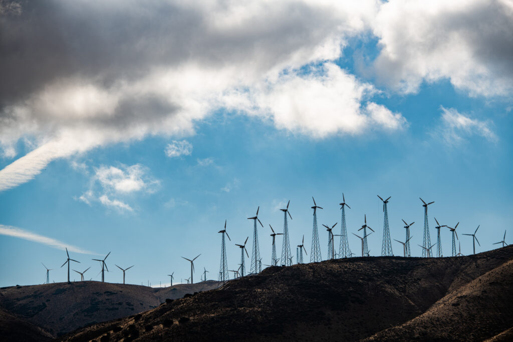 Wind farm with multiple wind turbines producing renewable energy, highlighting Galeforce Energy’s wind turbine maintenance, repair, inspection, and performance optimization services in the United States.